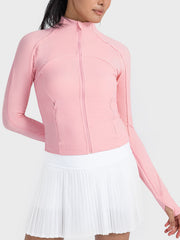 Pink ribbed performance zip-up jacket with thumbholes and a zippered pocket.