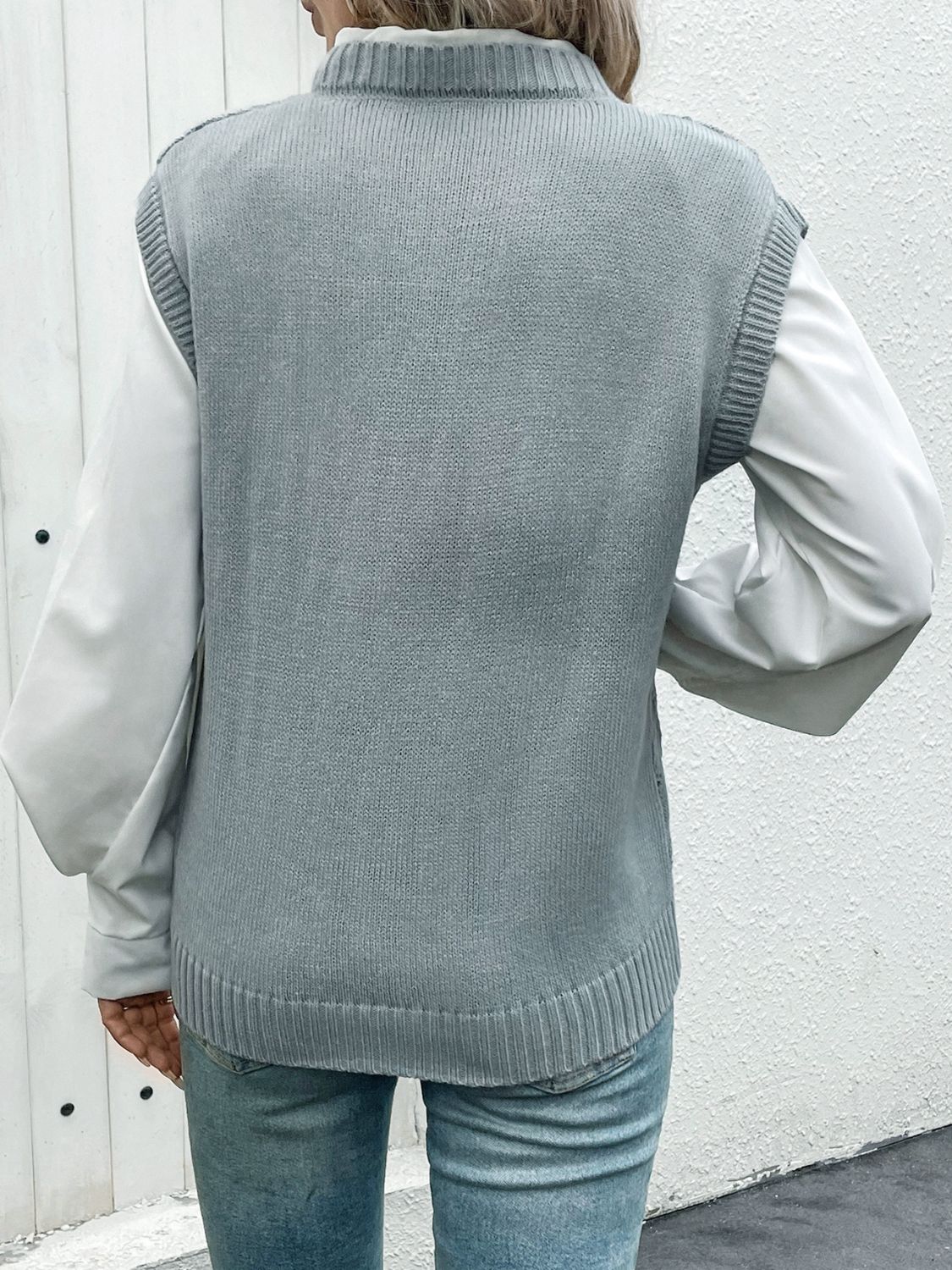 Gray acrylic diamond knit V-neck vest with ribbed trim, layered over a white shirt.