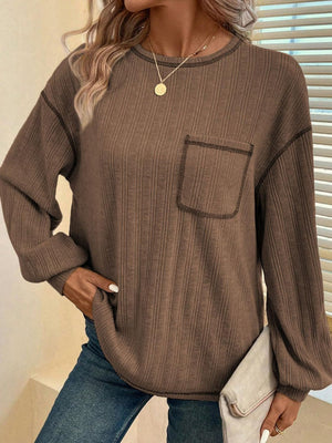 Dust Storm ribbed knit sweater with contrast stitching on pocket and neckline.