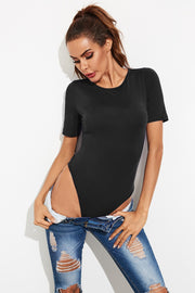 Black crew-neck jersey bodysuit with short sleeves, styled with ripped jeans.