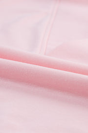Blush pink V-neck tee with puff sleeves, close-up of soft fabric texture.