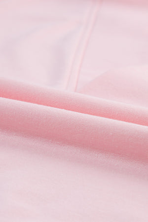 Blush pink V-neck tee with puff sleeves, close-up of soft fabric texture.