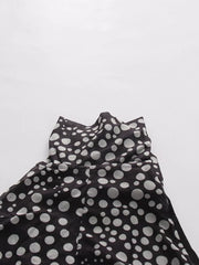 Chic polka dot halter maxi dress with a sheer overlay and ruched detail.