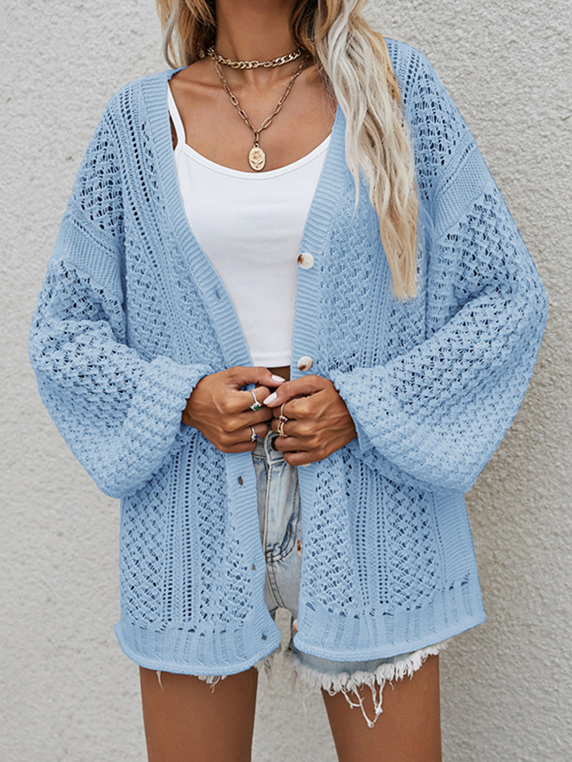 Open-knit button-down cardigan in Cloudy Blue with balloon sleeves and a relaxed fit.