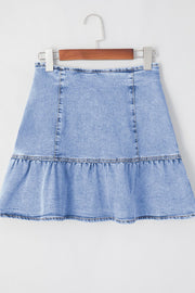 Asymmetrical denim mini skirt in medium wash with a ruffled hem.