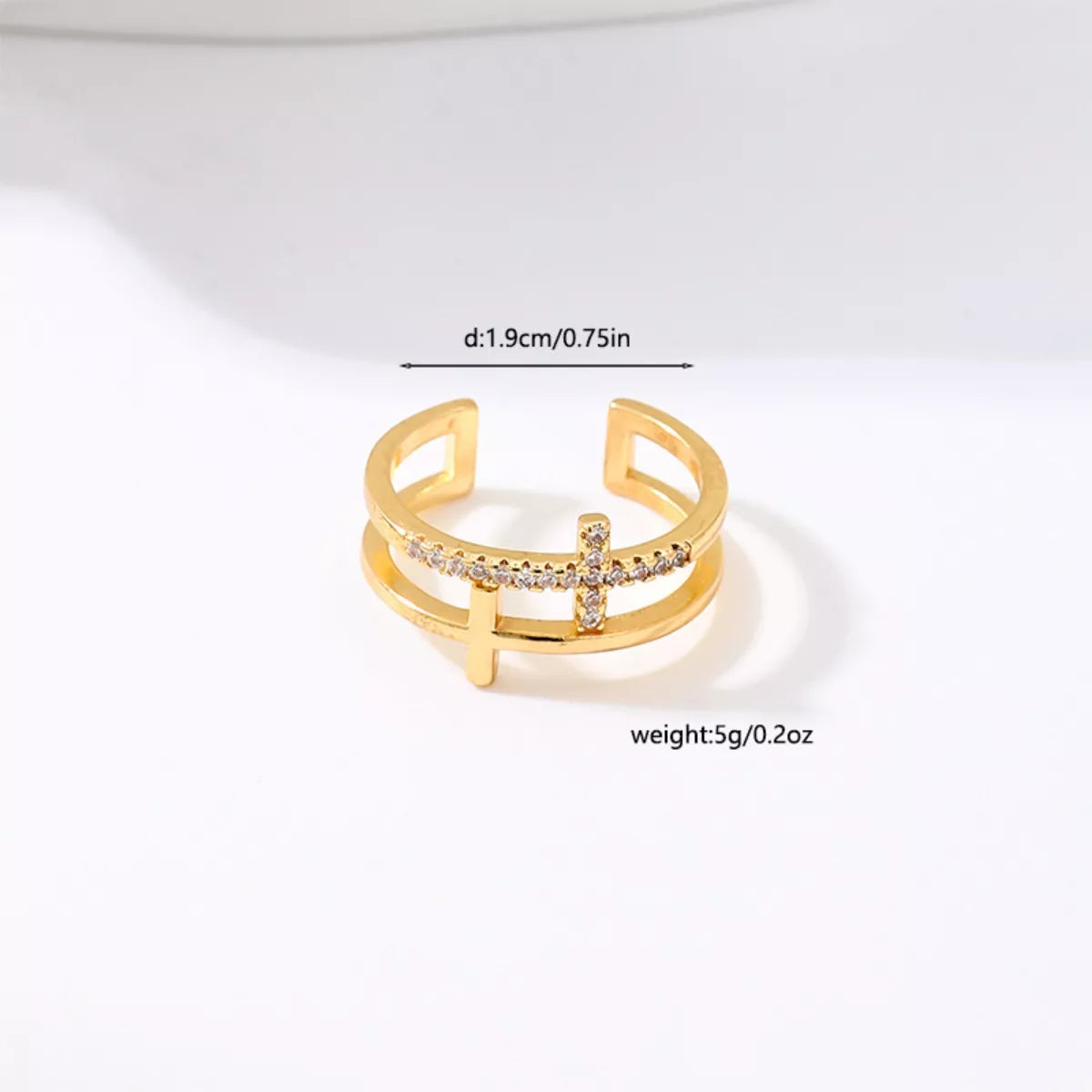 Golden open ring with rhinestone cross detail and double band design.