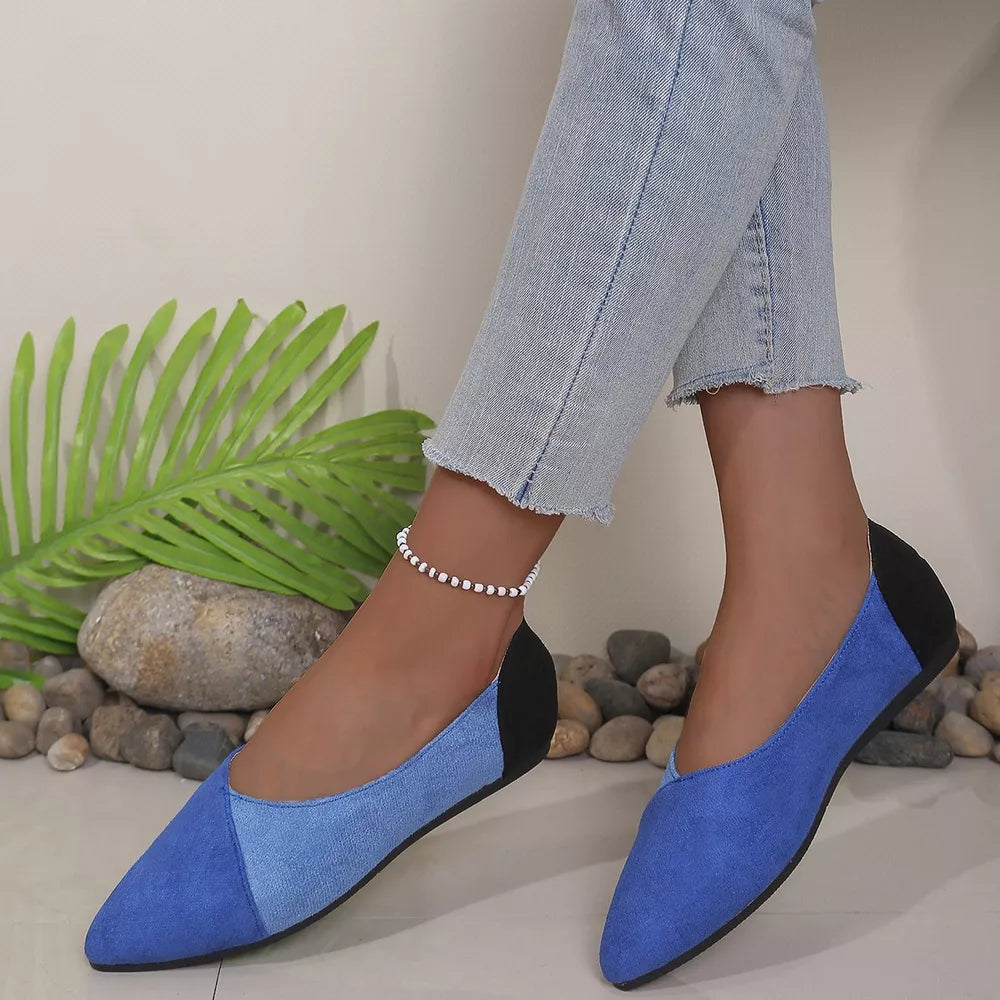Chic pointed-toe slip-on flats in blue and black color block with a pointed toe.