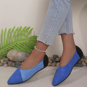 Chic pointed-toe slip-on flats in blue and black color block with a pointed toe.