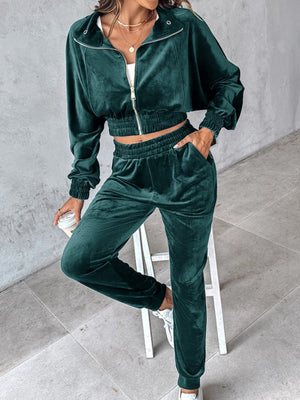 Deep teal velvet crop tracksuit with zipper detail and elastic waistband.