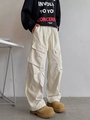 Relaxed fit apricot cargo pants with multiple pockets and drawstring waist.
