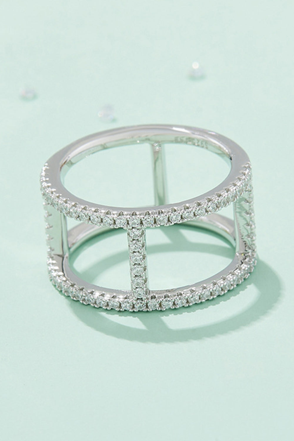 Silver geometric pave moissanite statement ring with open cage design.