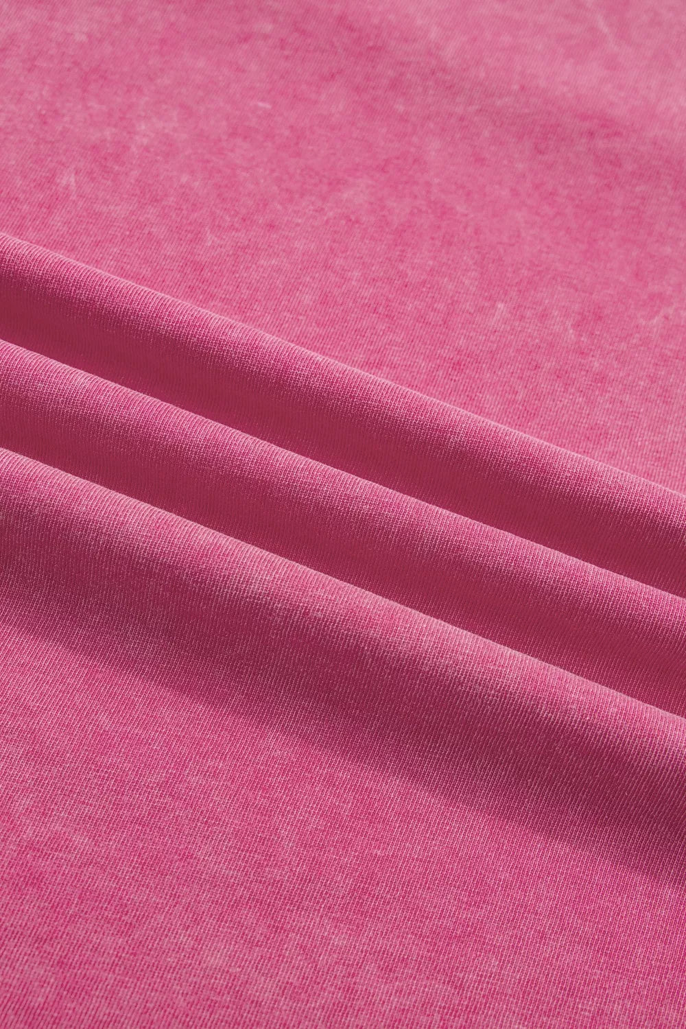Pink mineral wash t-shirt with subtle texture and soft cotton fabric.
