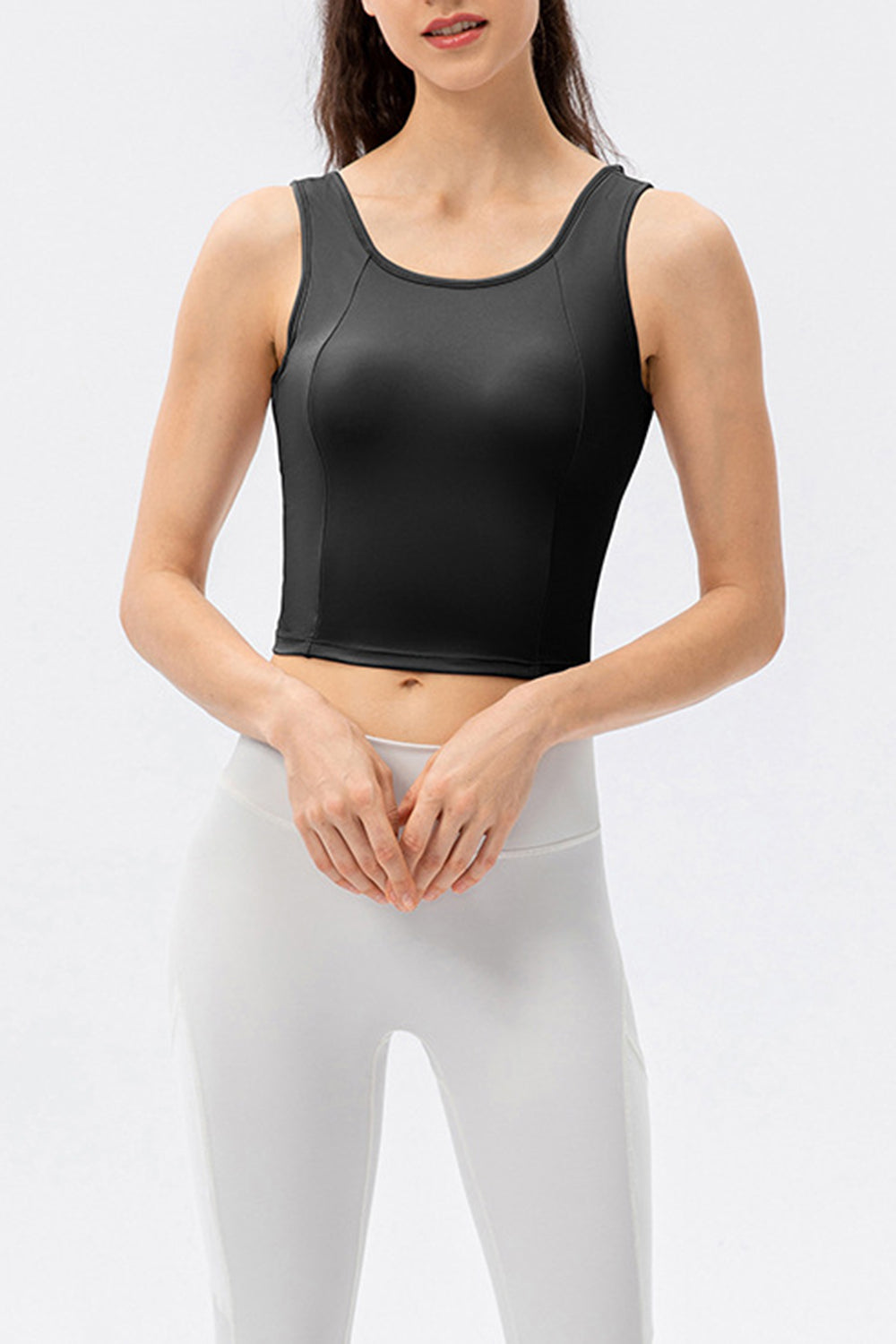 Black active crop top with sculpted seams and scoop neckline.