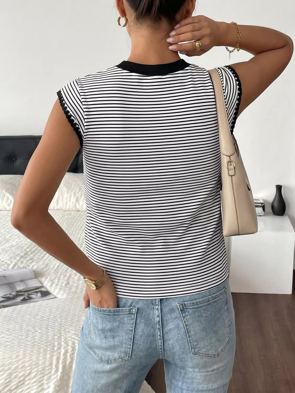 Black and white striped crew neck tee with black trim on sleeves and neckline.