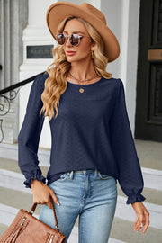 Dark Blue textured puff sleeve blouse with ruffled cuffs and crew neck.