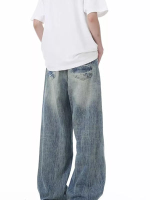 Men's distressed vintage wide-leg jeans in light blue denim.