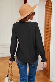 Black eyelet blouse with ruffle cuffs and textured pattern