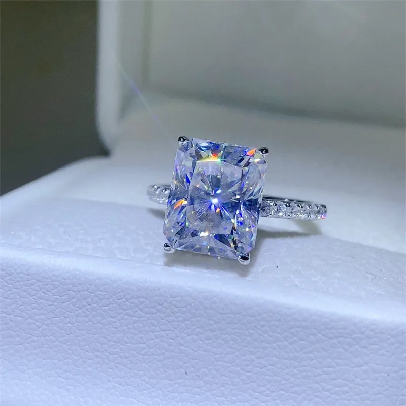 Radiant cut moissanite ring with pavé band in silver.