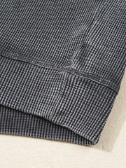 Dark gray waffle knit sweatshirt showing texture and seam detail.