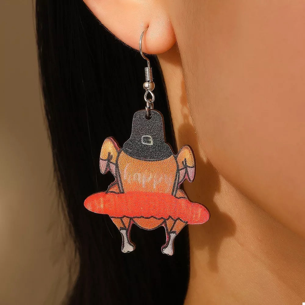 Thanksgiving turkey charm dangle earrings in acrylic with orange and black details.