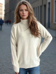 Cream relaxed raglan turtleneck knit sweater with ribbed cuffs and hem.