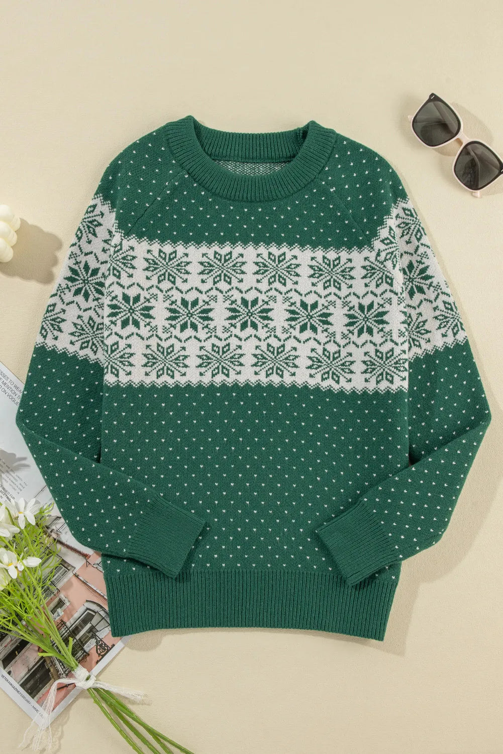 Festive Fair Isle sweater in dark green with white snowflake pattern, crew neck, long sleeves.