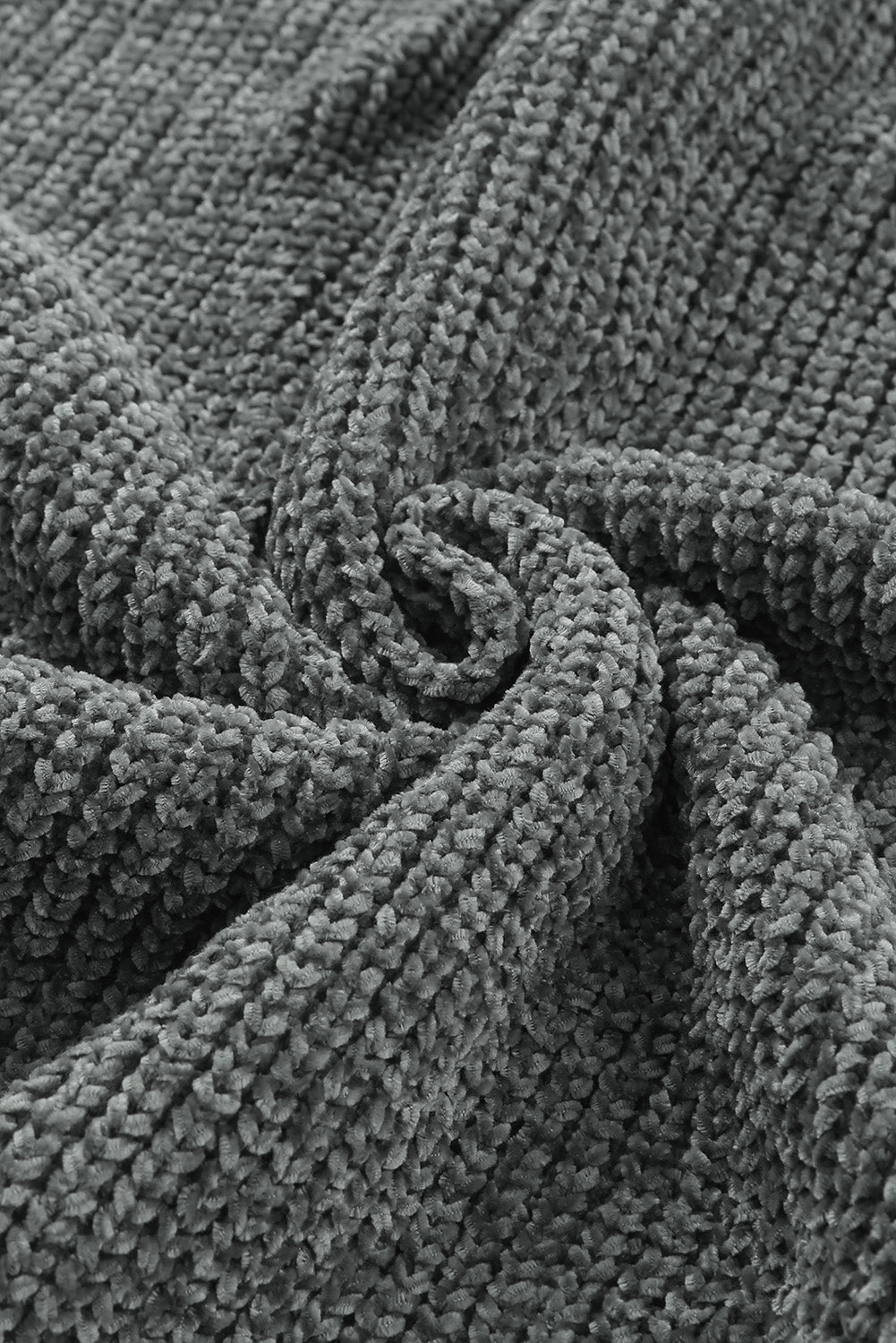 Distressed knit sweater in dark gray with a plush, textured fabric detail.