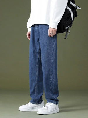 Casual oversized men's dark wash denim jeans with pockets, relaxed fit.
