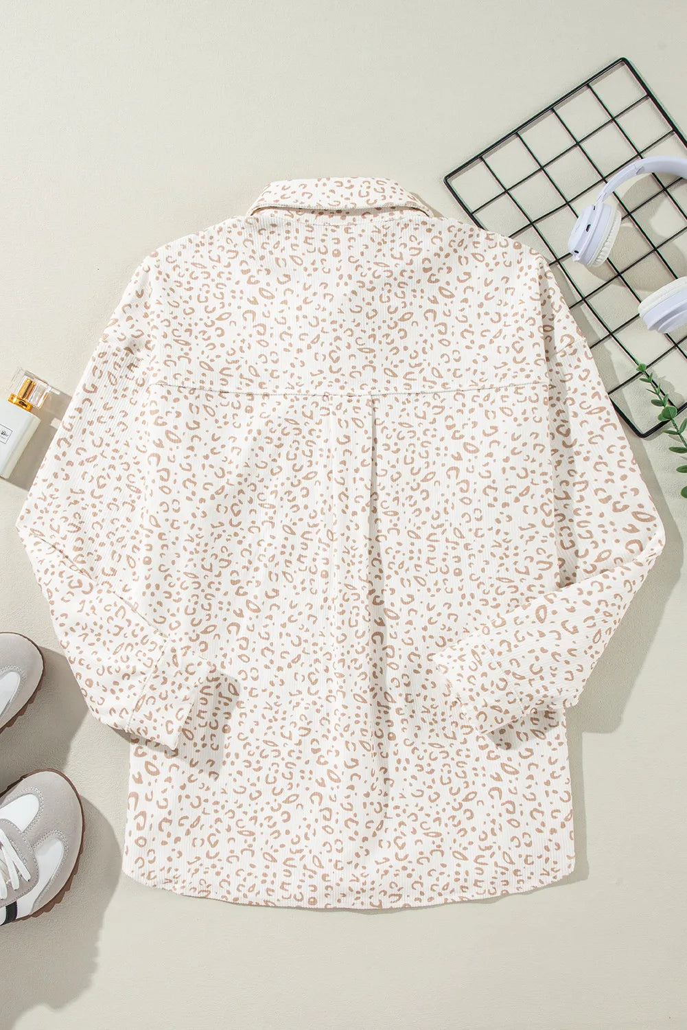 Leopard print overshirt with collared neckline and button-down front.