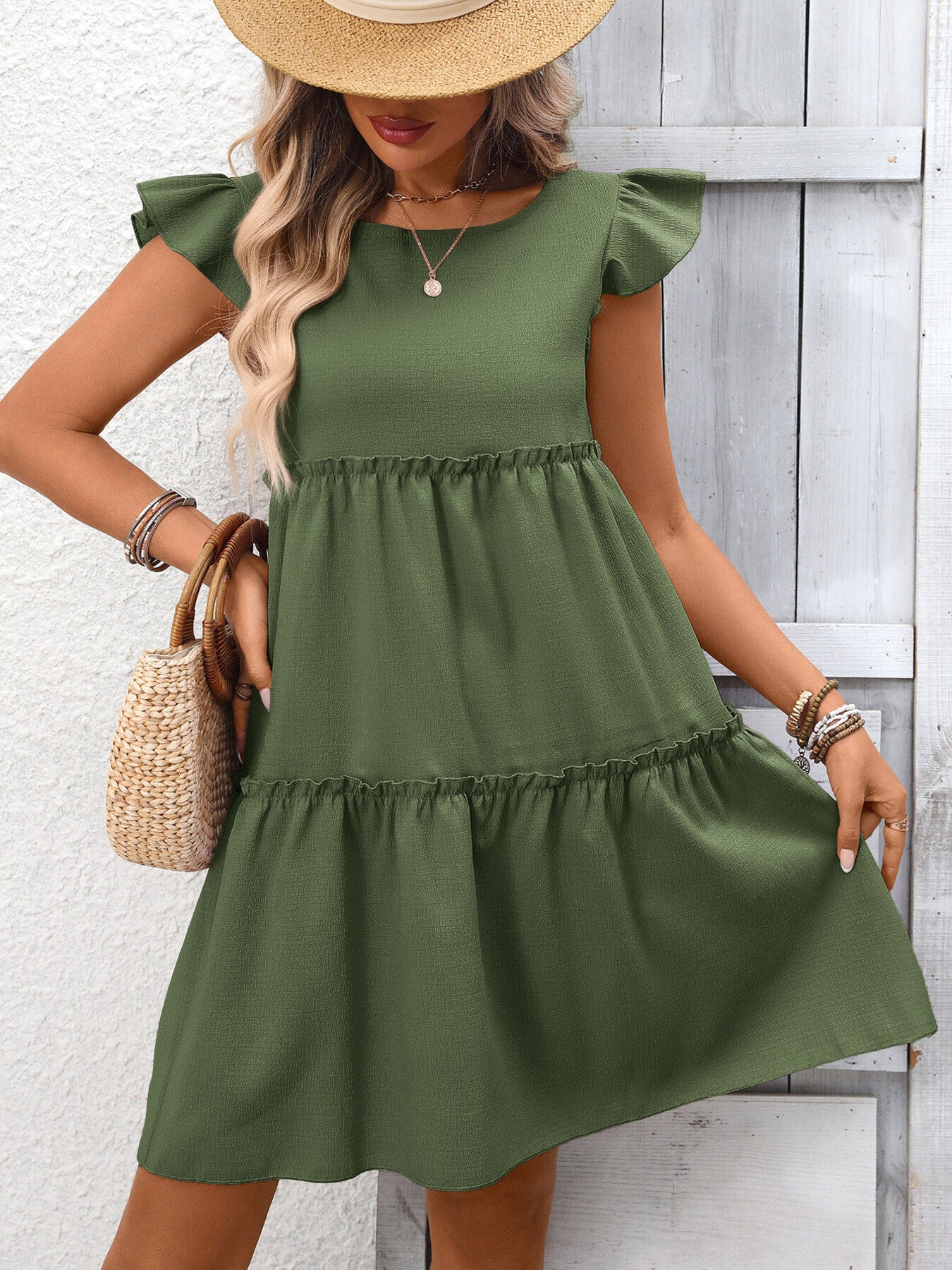 Army green ruffled cap sleeve mini dress with tiered skirt and round neckline.