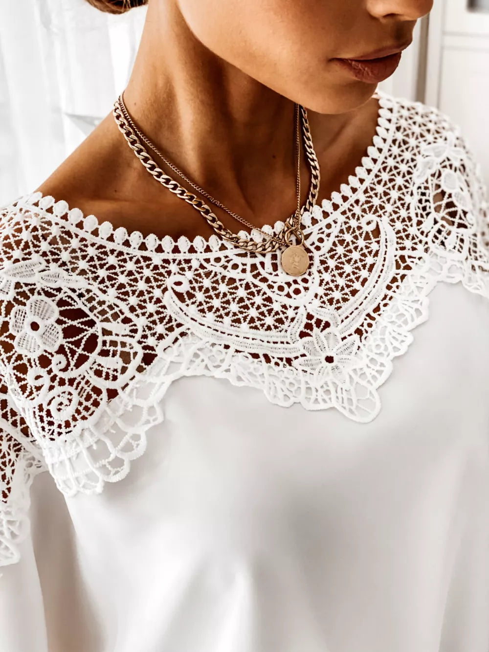 White lace-tie maternity shirt with intricate lace neckline detail.