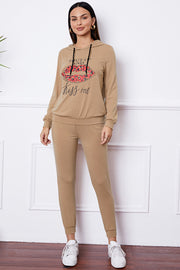 Khaki loungewear set with "Shut Up And Kiss Me" lip graphic hoodie and joggers.