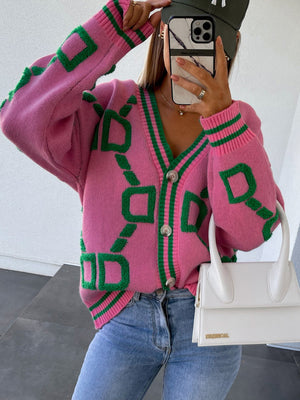 Hot Pink acrylic geometric chain knit cardigan with green trim and buttons.