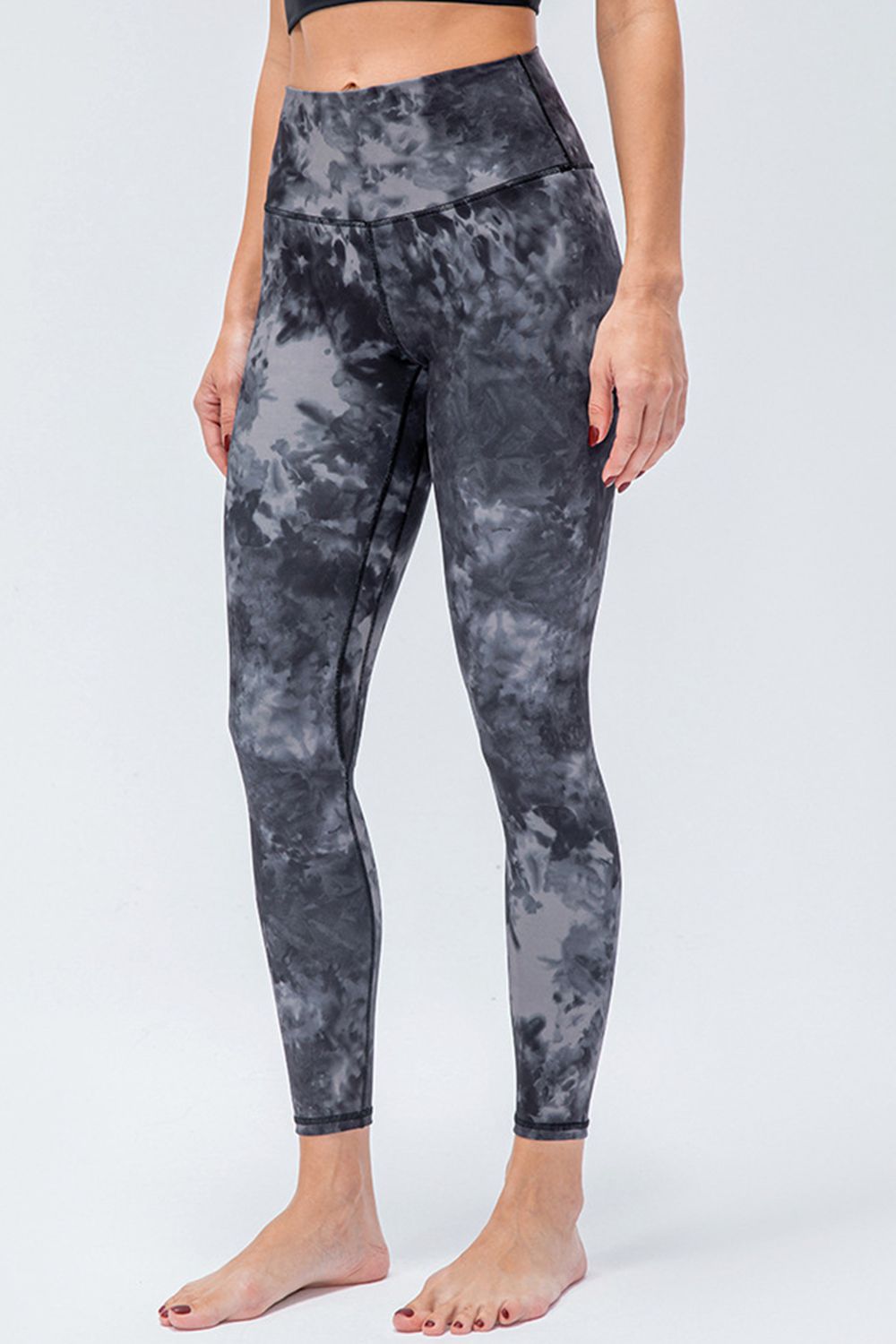 High-rise performance leggings in a black and gray tie-dye pattern.