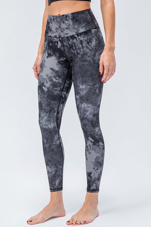 High-rise performance leggings in a black and gray tie-dye pattern.
