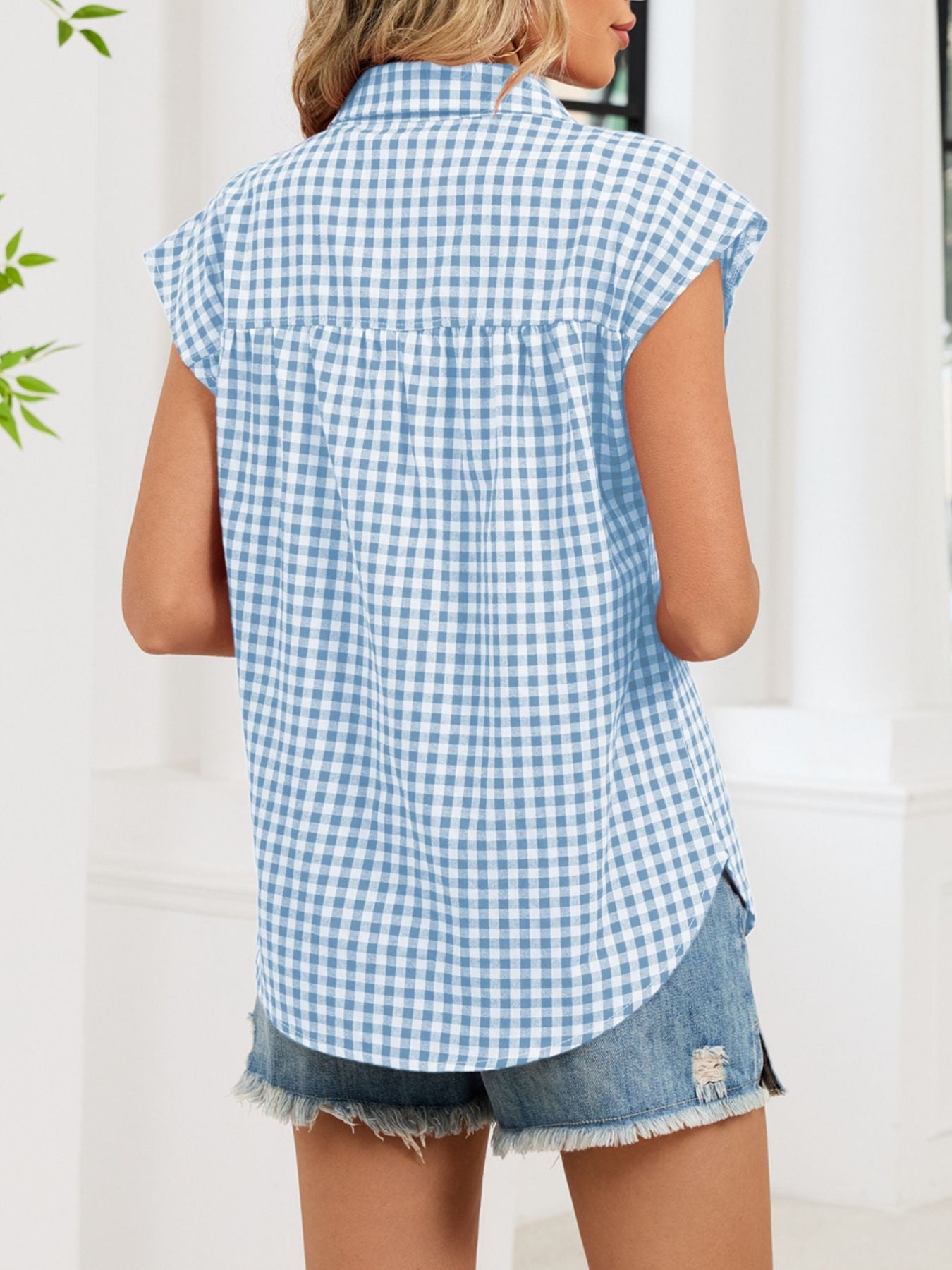 Sky blue gingham cotton shirt with cap sleeves and button-down front, shown from the back.