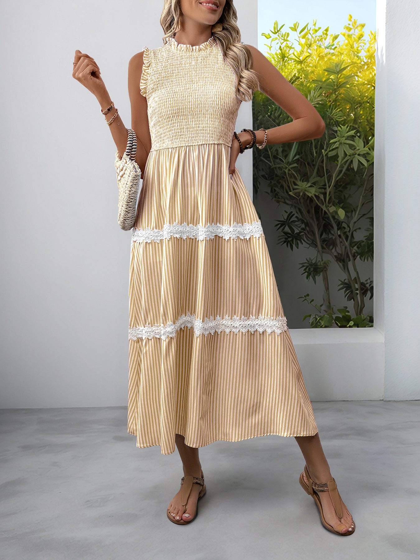 Yellow striped midi dress with smocked bodice and lace trim tiers.