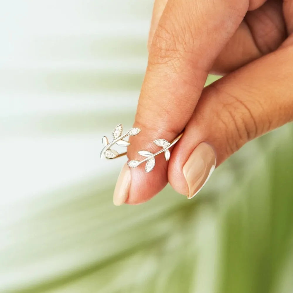 Silver leaf ring with zirconia accents, delicate vine design.