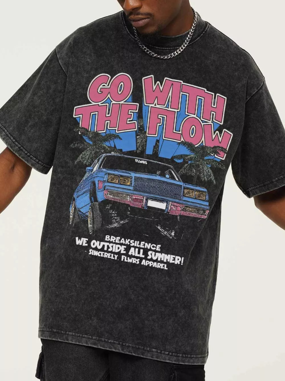 Vintage graphic oversized men's tee in black with "Go With The Flow" text and car graphic.