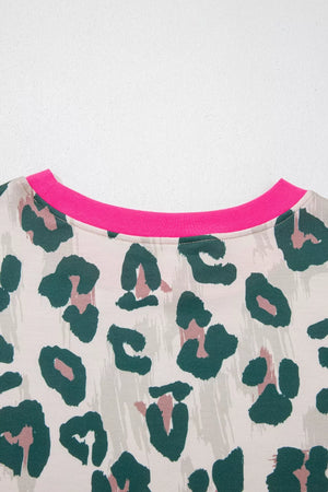 Pajama top with leopard print, crew neck, and pink trim detail.