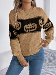 Camel knit sweater with black jack-o'-lantern intarsia pattern and crew neck.