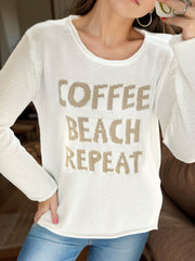 White knit jumper with "Coffee Beach Repeat" graphic, crew neck, long sleeves.