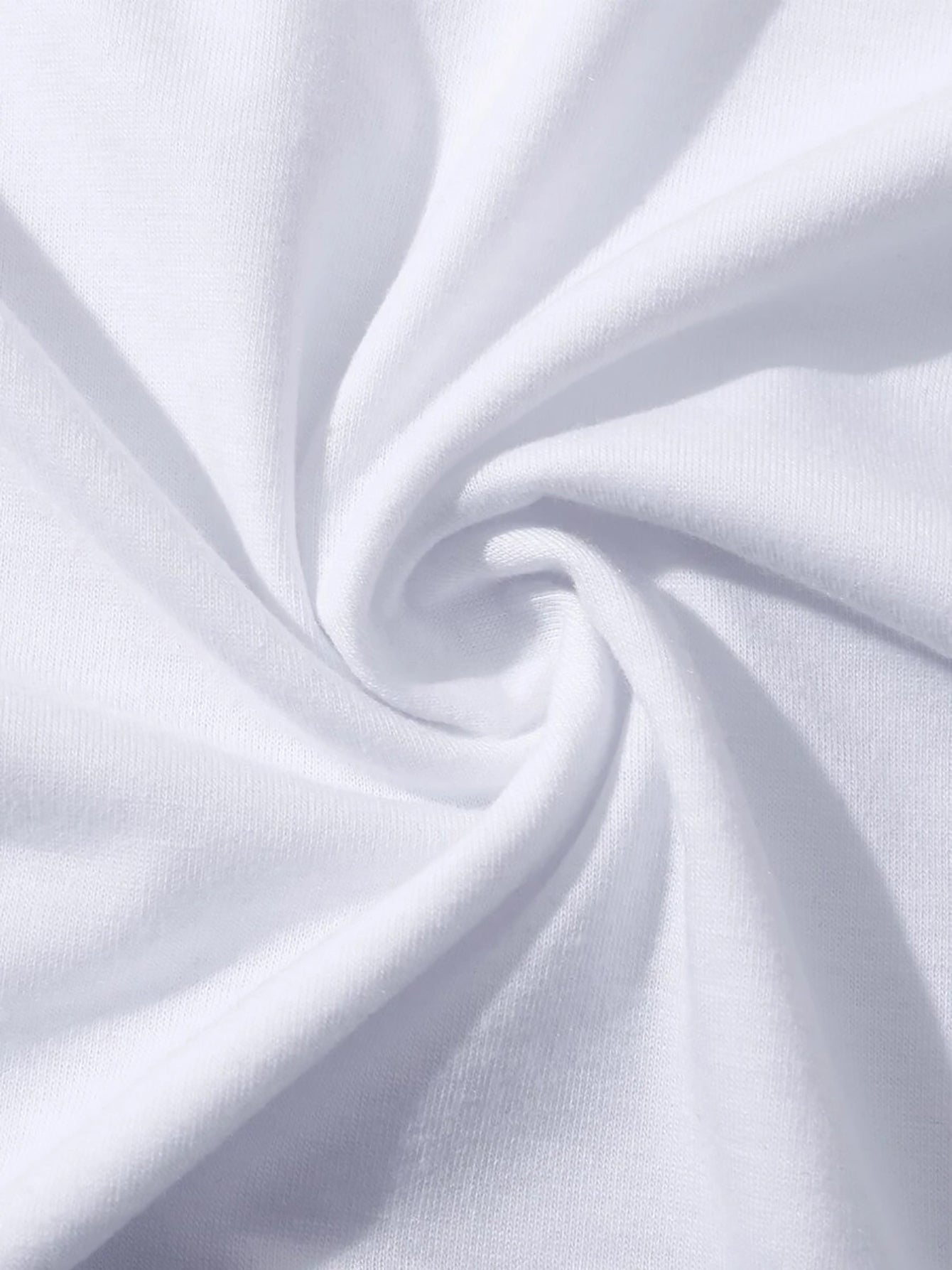 White t-shirt fabric detail with soft folds and texture.