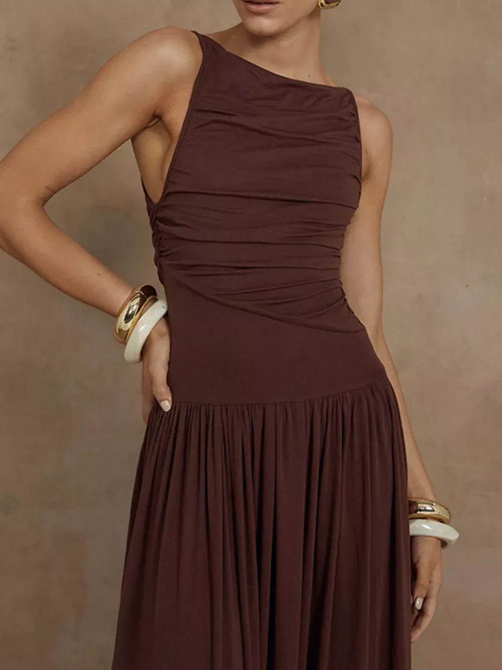 Brown ruched asymmetric maxi dress with a gathered skirt.