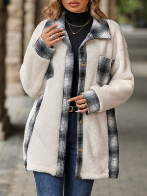 Teddy shacket with plaid accents and button front, featuring a fuzzy white exterior and gray plaid trim.