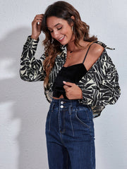 Checkerboard cropped shirt jacket in black and white leaf print with button front.