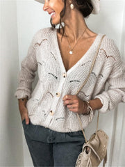 Beige scalloped knit button-down cardigan with openwork details and wooden buttons.