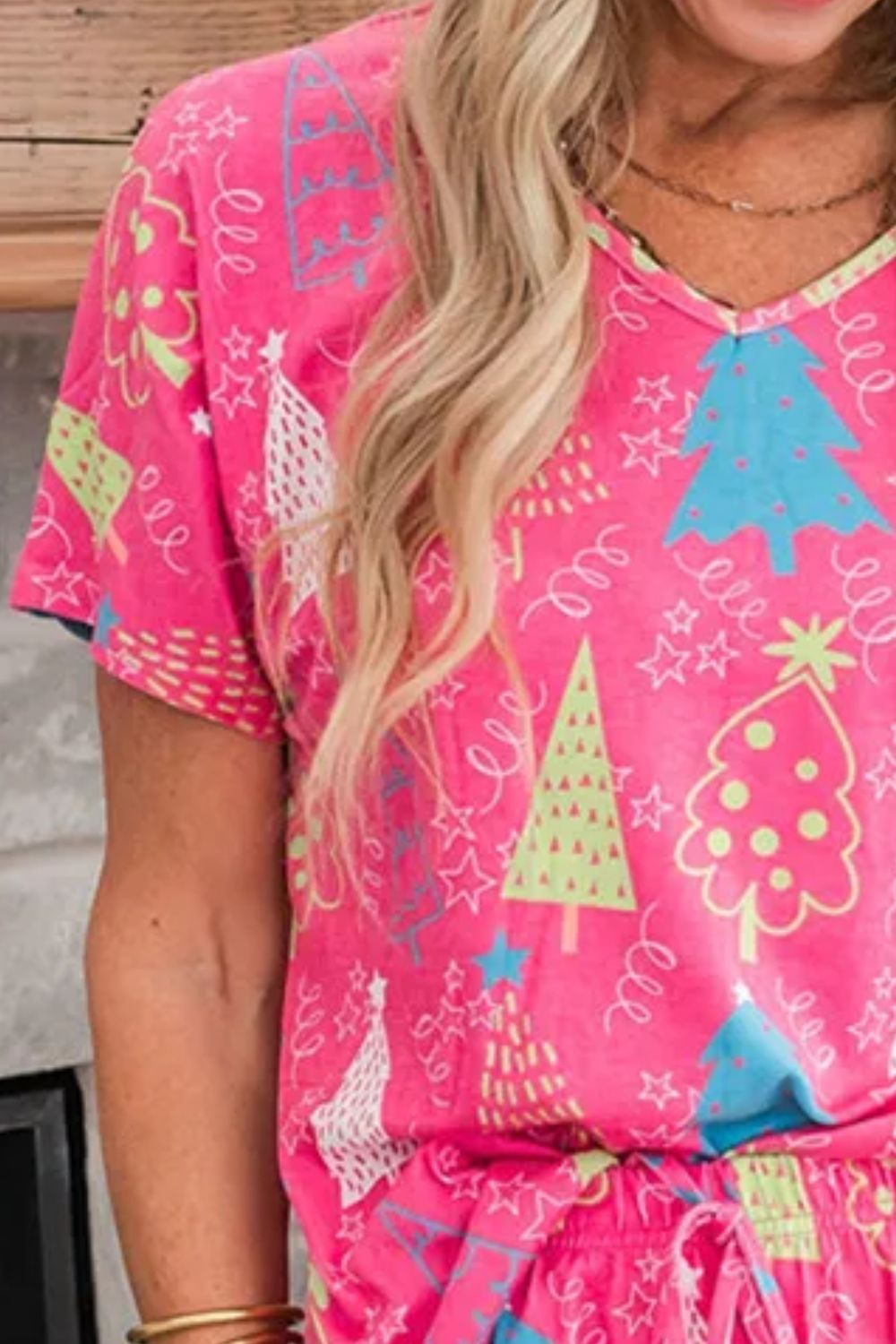 Hot pink V-neck lounge set with festive Christmas tree print and short sleeves.