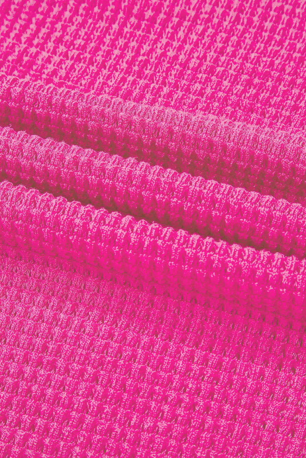 Hot Pink waffle knit V-neck top with slit hem detail.