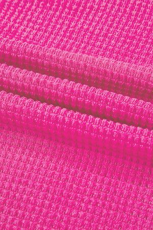 Hot Pink waffle knit V-neck top with slit hem detail.